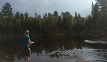 Man fishing from the shore in the BWCA